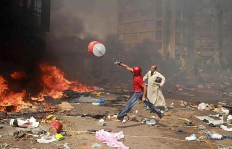 A supporter of the Egypt's ousted president Mohammed Morsi threw a water container onto a fire.
